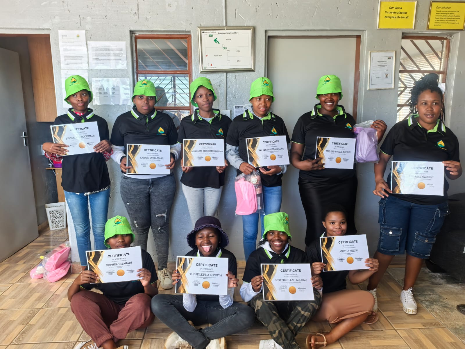 Young people proudly holding their training certificates