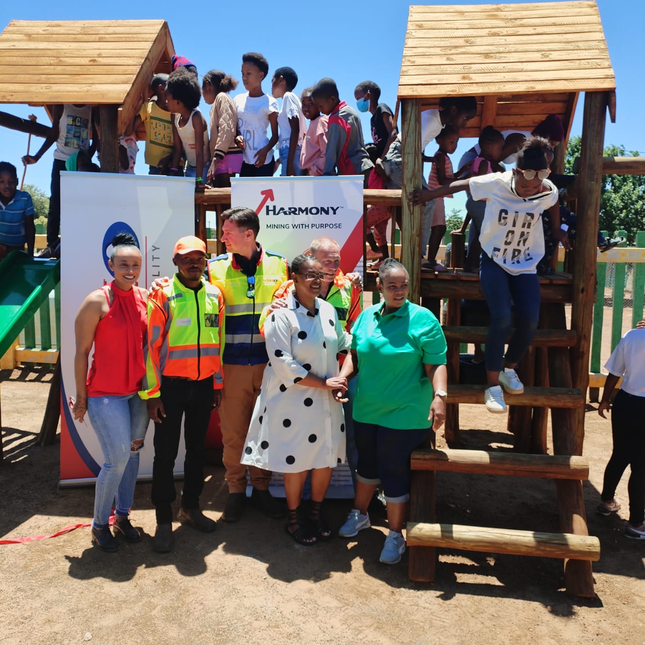 Children playing on the wooden playground donated by Harmony Mining